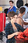 Beautiful Caucasian lady smiles in the laundromat