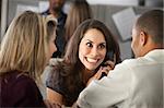 Excited woman office worker with colleagues on phone