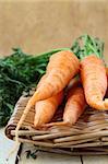 fresh baby carrots in a wicker basket