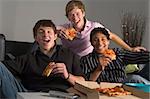 Teenagers Having Fun And Eating Pizza