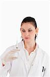 Doctor preparing a syringe on a white background