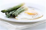Asparagus with eggs on white plate
