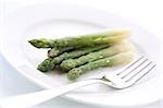 Boiled asparagus on the white plate