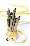 Raw asparagus and measuring type isolated on a white background