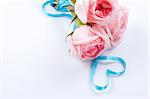 A bouquet of roses with ribbon in heart shape