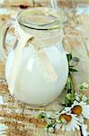 pitcher of milk on a wooden table rustic still life