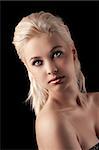 beauty shot of a sweet young girl with blonde hair on black background