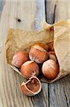 hazelnuts in a paper on a wooden table