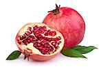 Juicy pomegranate and its half with leaves. Isolated on a white background