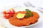 Delicious Wiener Schnitzel with lemon and tomatoes