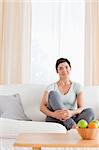 Portrait of a woman sitting on a sofa in her living room