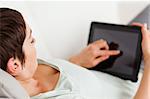 Woman using a tablet computer in her living room