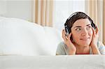 Short-haired woman listening to music looking away from the camera