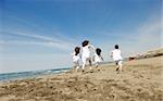 group of happy child on beach who have fun and play games