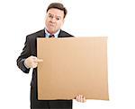 Desperate, unemployed businessman holding up a message on a cardboard box.  Blank for your text.