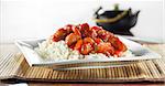 wide aspect ratio shot of a dish with sweet and sour pork on rice