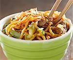 beef lo mein in a bowl with chopsticks