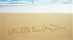 The inscription on the surface beach sand - relax