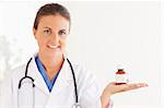 Portrait of a brunette doctor looking at some pills in the surgery