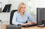 Working woman in front of a screen in an office