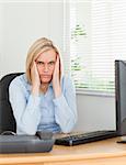 Frustrated working woman looking into camera in an office