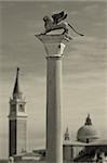 Column with lion - symbol of Venice in front of San Giorgio Maggiore church in Venice, Italy.