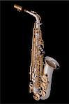 A complete professional silver and gold alt saxophone isolated on a black background.