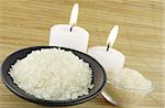 candle and bath salt over wooden mat