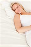 Portrait of a woman lying down in her bedroom