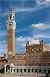 The tower of the Torre del Mangia, Sienna against a deep blue sky