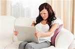 Woman reading unpleasent mail in her livingroom