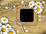 Vintage photo frames and white daisies on an old, cracked background