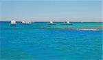 group of white boats on turquoise water of Red Sea, Egypt
