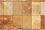 Rough brown marble tiles at building facade