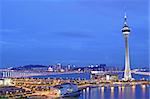 Urban landscape of Macau with famous traveling tower under sky near river in Macao, Asia.