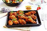 Hot chicken wings on baking tray