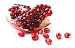 Slice of pomegranate and juicy seeds isolated on white background