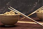 A freshly cooked bowl of rice with wooden chopsticks to enjoy a taste of the orient.