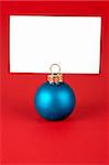 Memo over a blue Christmas ball on a red background