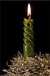 Green candle decorated with wax tap