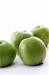 Fresh green apples on a white background.