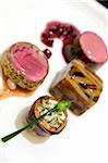 Seared Australian loin of lamb, shiraz reduction with pomegranate, braised shank and thyme, eggplant zucchini and tomato baked mousaka, artichoke and feta bake with wild garlic chives