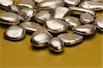 Silver pebbles against a gold background