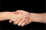 Handshake isolated on black background