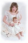 mother and baby with rabbit are posing on white and looking into the camera