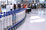 Passengers lining up at the check-in counter at the modern international airport