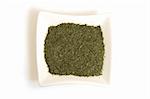 dried dill in square white bowl isolated