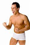 Young muscular man looks very happy / screaming. Isolated on white in studio.