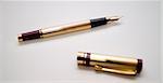 old golden pen with white background defocused cap