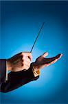 conductor's hands on blue background
